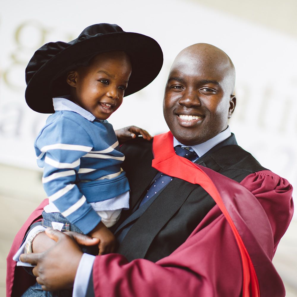 Graduate holding a young child -essex